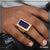 Man’s hand with 1 Gram Gold Forming Blue Stone and Diamond Glittering Ring
