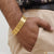 Man wearing a gold bracelet with ’love’ charm - 1 Gram Gold Nawabi 3 Line Delicate Design Bracelet