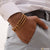 Man wearing superior quality gold plated bracelet from 3 Line Rudraksh - Style B462