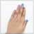 Woman’s hand with blue mani and diamond ring on 92.5 sterling silver decorative design ring.