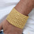 A man wearing a Bahubali Distinctive Design gold plated bracelet for men.