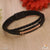 Black and golden leather braided bracelet with white