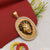 Embossed lion face pendant in oval shape with diamonds -