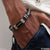 Man wearing high-quality black leather bracelet with silver clasp