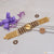 Gold plated Rudraksha bracelet with diamond artisanal design and purple ribbon