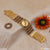 Gold plated Rudraksha bracelet featuring diamond artisanal design with flower on the side