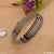 Silver and black mixed funky design bracelet with metal clasp on table