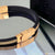 Trending fancy black and gold rubber bracelet displayed on table