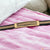Golden buckle on pink blanket displayed on Very Trending Fancy Black Rubber Bracelet - Style A419